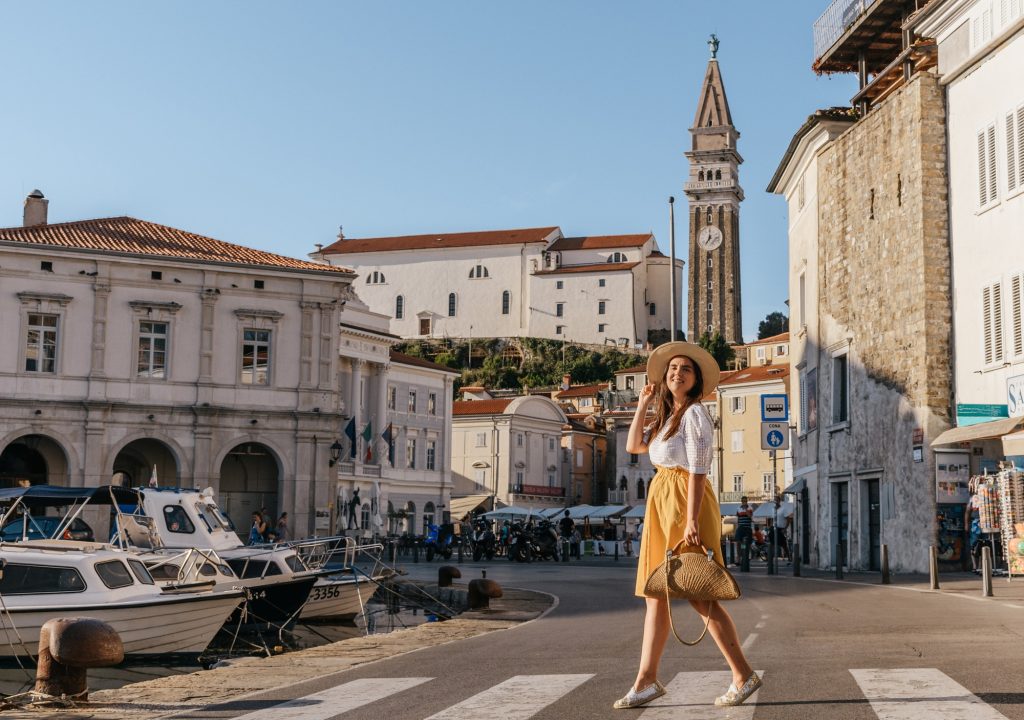 Day trip from Ljubljana to Piran – happy travelers exploring the seaside town and its beautiful coastal views.