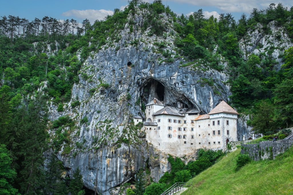 Why Visit Postojna Cave from Bled – stunning Predjama Castle built into a cliffside near the cave